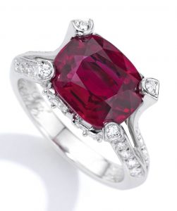Lot 57 - Platinum, Ruby and Diamond Ring, Van Cleef & Arpels. Four claws that arise by the bifurcation of the upper shank of the ring is shown