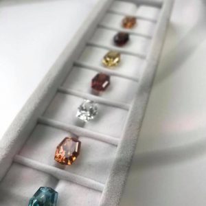 PAIRS & SUITES HONORABLE MENTION - PHILLIP YOUNGMAN, SUITE OF 36 SPECIALTY CUT ZIRCON - 140.27 CT. T. W.